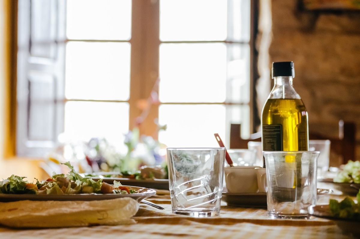 Bottle of Lebanese extra virgin olive oil on rustic wood with linen