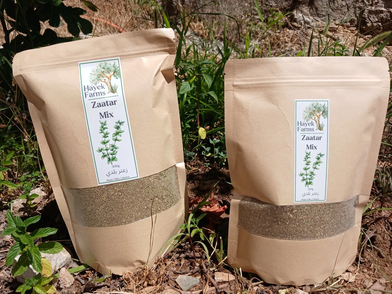 Two Hayek Farms zaatar bags among wild herbs in the grove